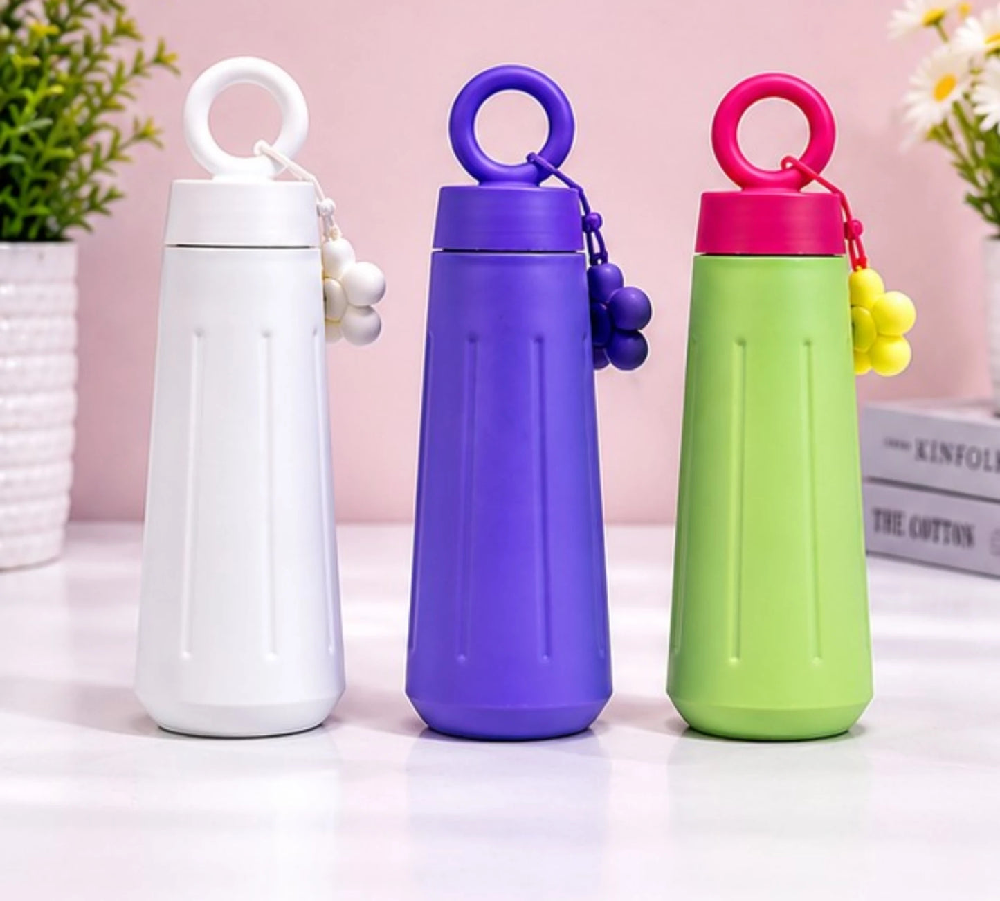 Cute stainless steel insulated water bottle with daisy flower charm and carry handle.